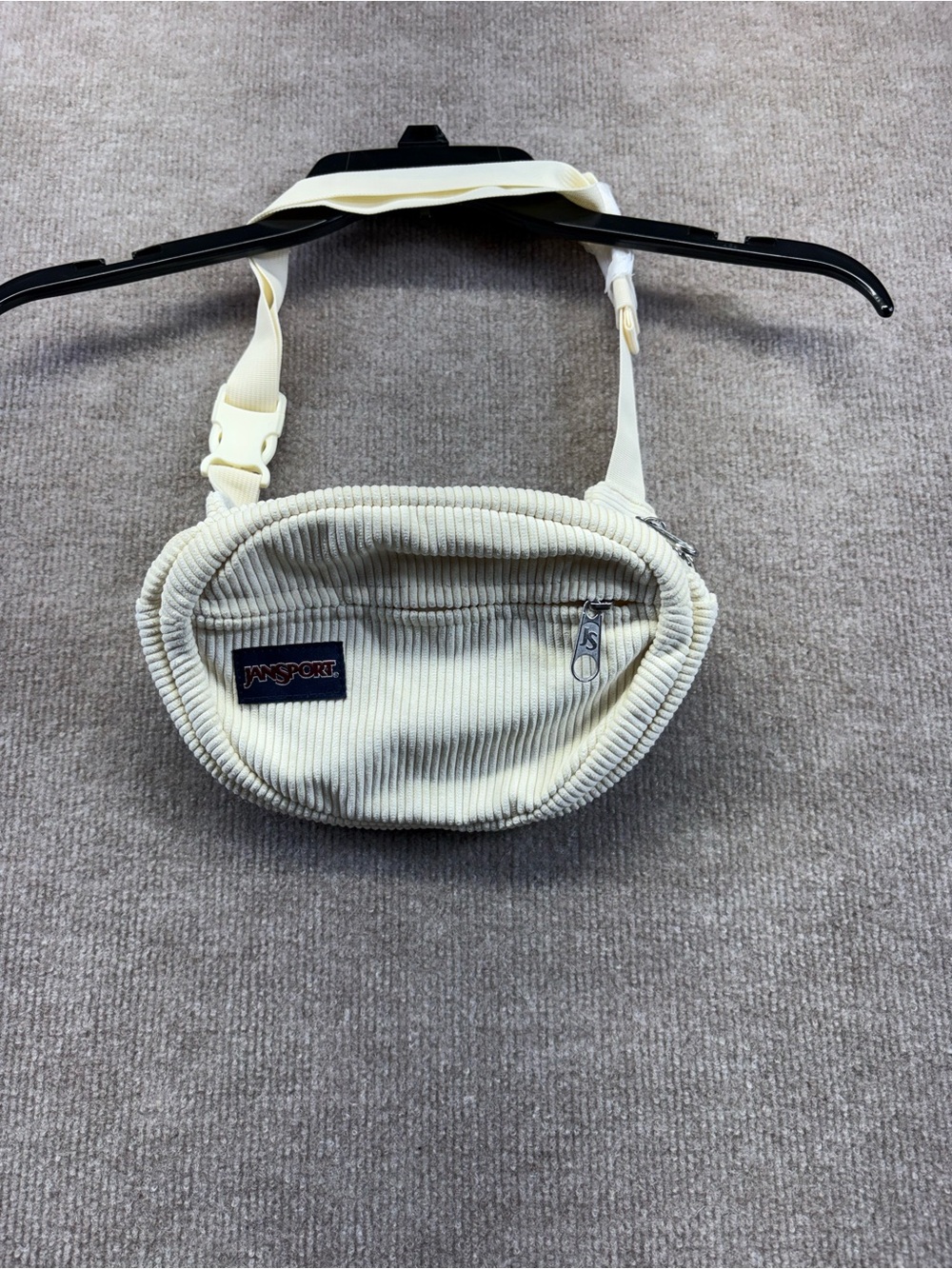 JanSport Fifth Ave FX Fanny Pack in coconut corduroy, featuring a soft ribbed te